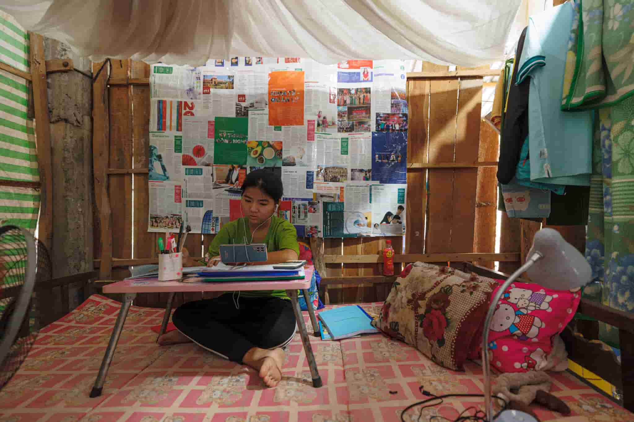 A craftswoman works on a quilt for Mekong Quilts in her home. Photo by Mervin Lee