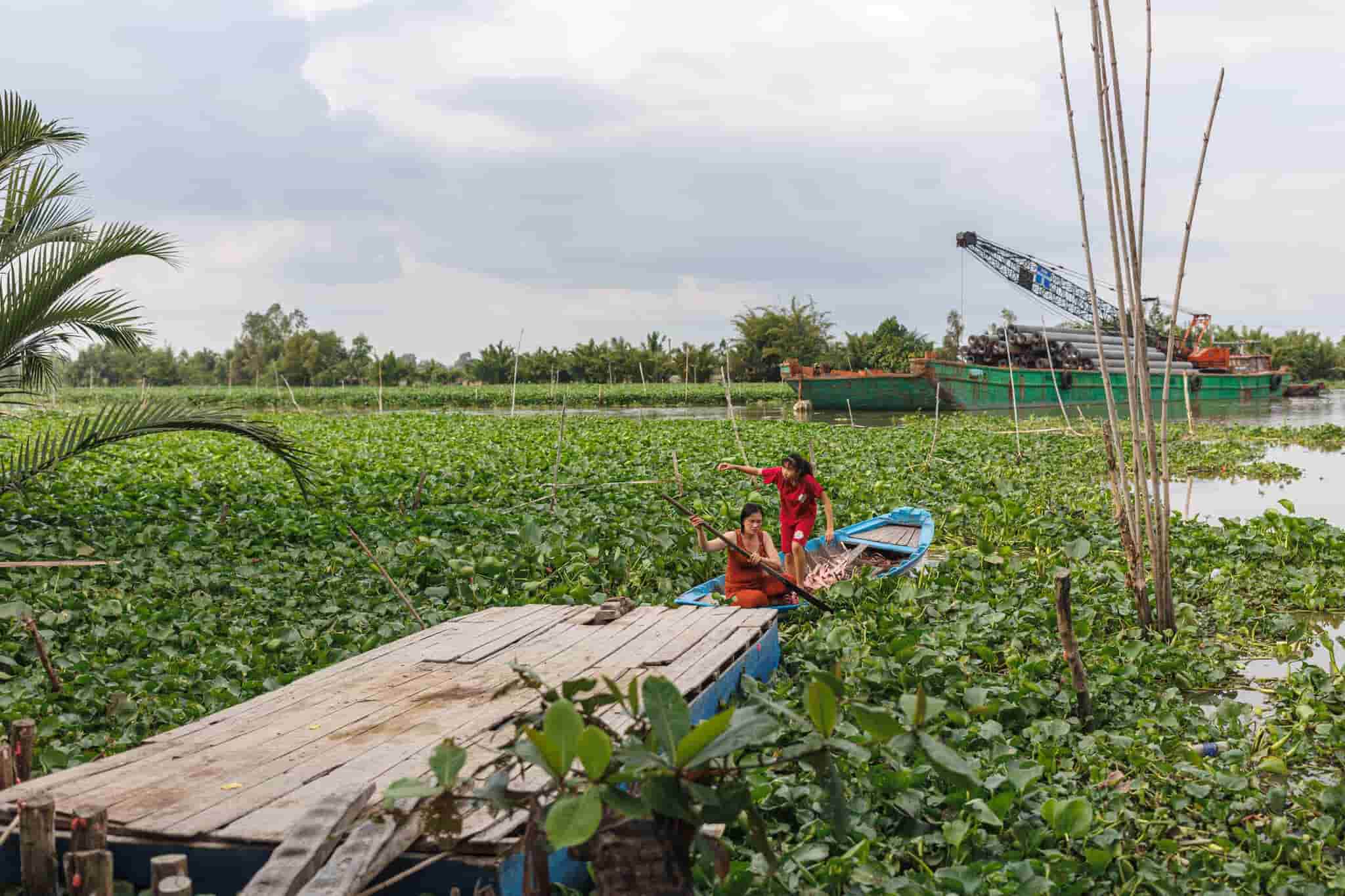 Villagers crossing the many waterways of Hậu Giang province. Photo by Mervin Lee