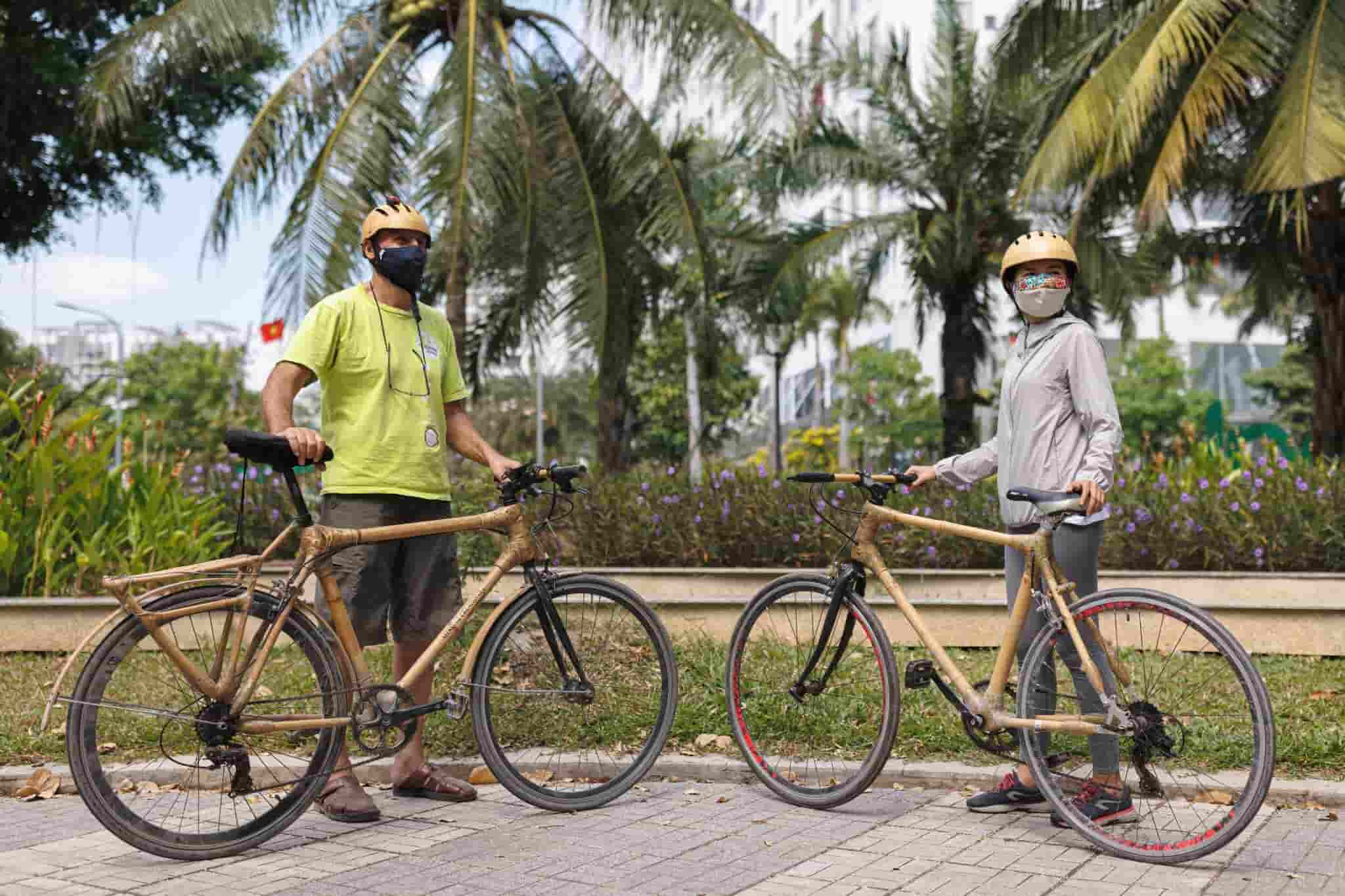 Two cyclists pose with their bamboo bicycles made by Mekong Quilts. Photo by Mervin Lee