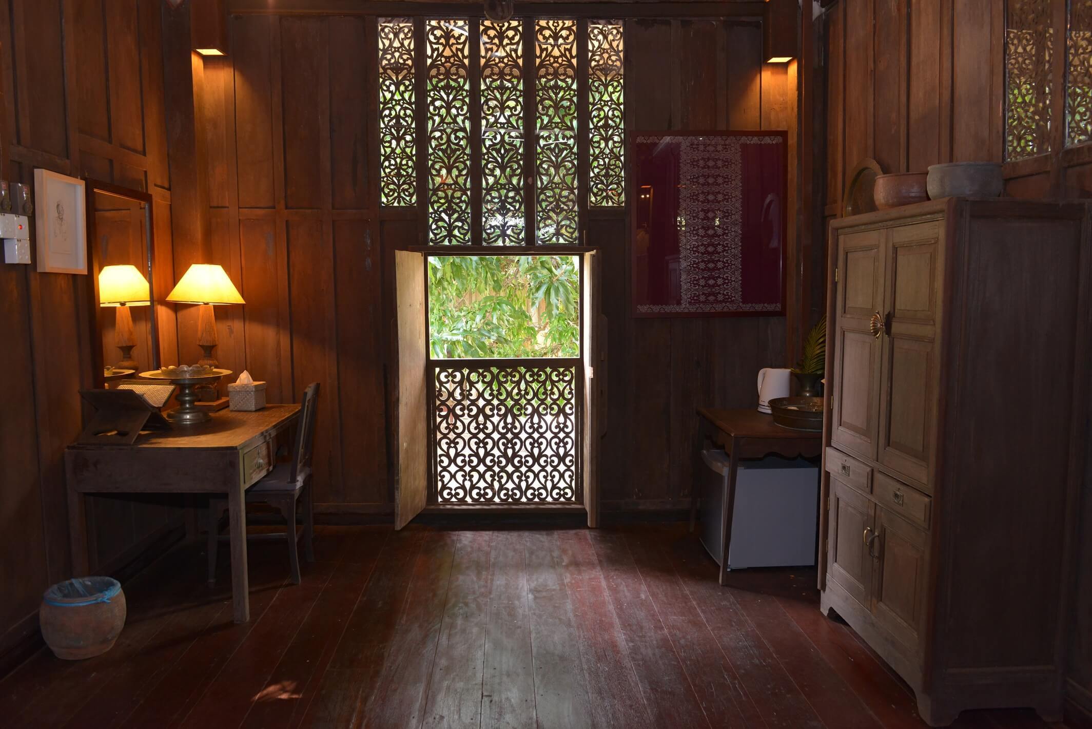 Amid a wood-panelled interior polished to a lustrous sheen, a window with delicate carvings takes centre stage. Photo courtesy of Terrapuri Heritage Village 